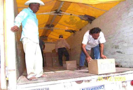 Workers unload boxes