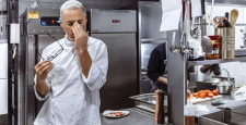 Chef at industrial kitchen in restaurant feeling burnt out (Getty Images/ljubaphoto)
