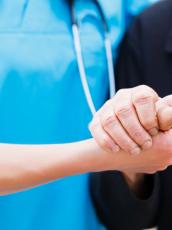 Doctor holding patient hand