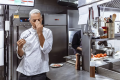 Chef at industrial kitchen in restaurant feeling burnt out (Getty Images/ljubaphoto)